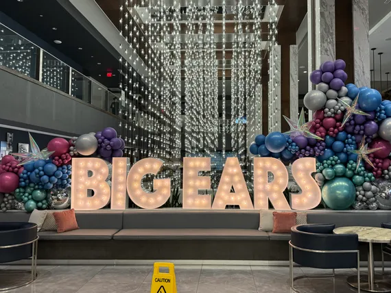 A big display of balloons and lights that say BIG EARS.