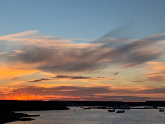 Sunset over boats in a marina.