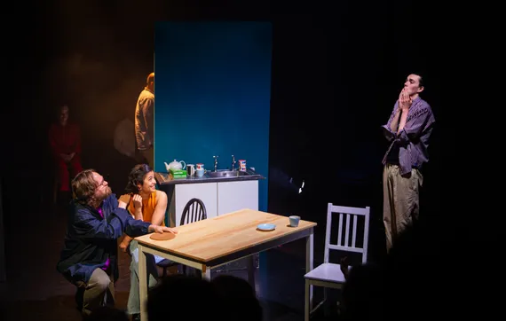On a kitchen stage set, Babette Hinterleitner and I almost hold hands at the kitchen table, while Hal Munger looks down at us, aghast.