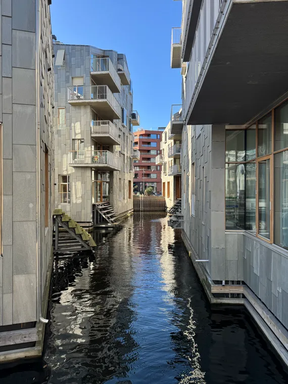 Two contemporary apartment buildings, the water of the Oslofjord between them.