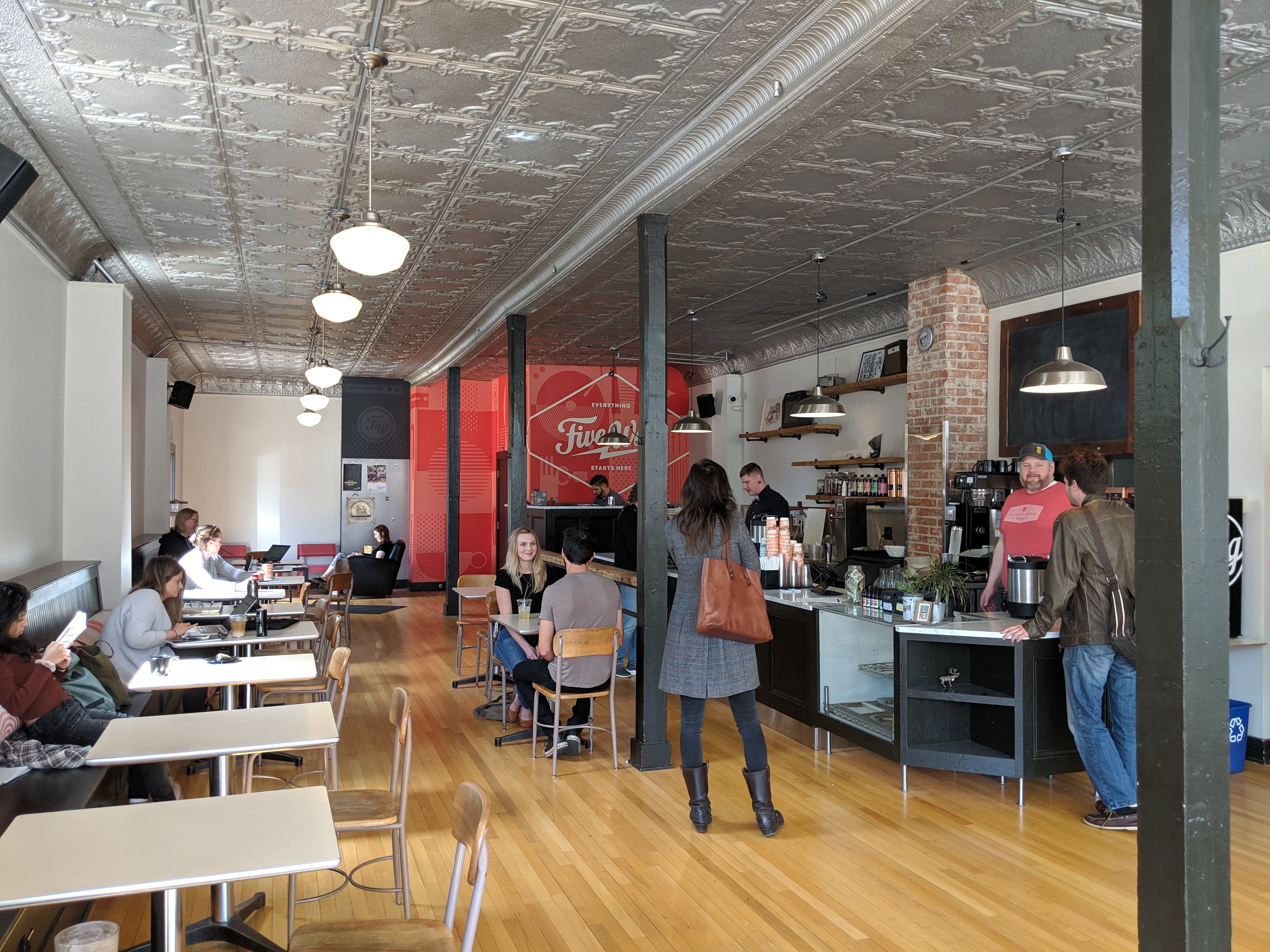 A photo of the newly opened Five Watt Coffee Lyndale, with Lee and Caleb working behind the counter.